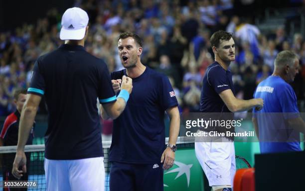 Great Britain team captain Leon Smith congratulates Dominic Inglot of Great Britain after he and his doubles partner Jamie Murray's victory in four...