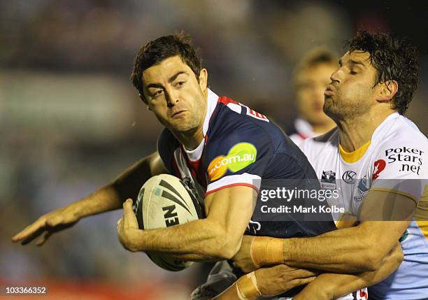 Anthony Minichiello of the Roosters is tackled during the round 23 NRL match between the Cronulla Sharks and the Sydney Roosters at Toyota Stadium on...