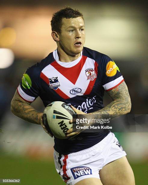 Todd Carney of the Roosters runs the ball during the round 23 NRL match between the Cronulla Sharks and the Sydney Roosters at Toyota Stadium on...