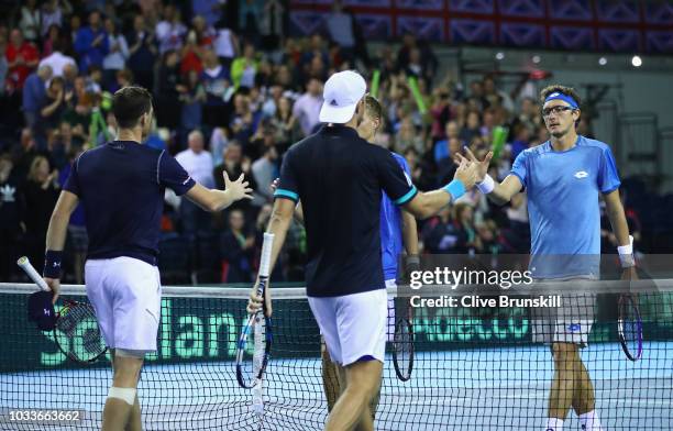 Jamie Murray and Dominic Inglot of Great Britain shake hands at the net after their four set victory against Denis Istomin and Sanjar Fayziev of...