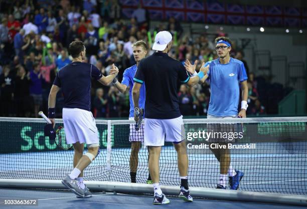 Jamie Murray and Dominic Inglot of Great Britain shake hands at the net after their four set victory against Denis Istomin and Sanjar Fayziev of...