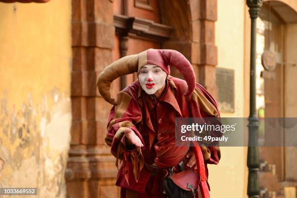 street performer dressed as a jester - a fool stock pictures, royalty-free photos & images