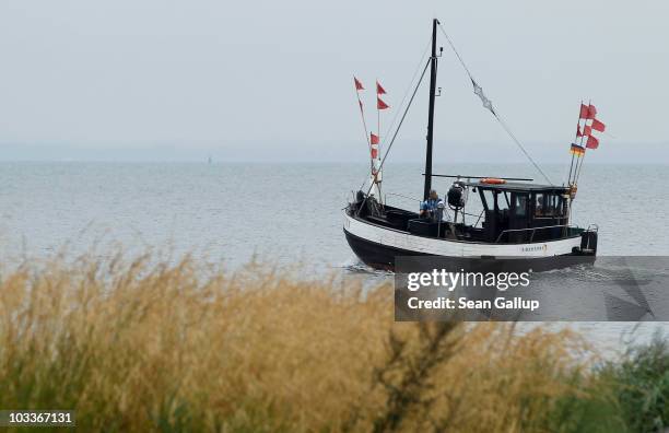 Veteran fishermen Klaus Raack and Reinhard Lay take their fishing boat into the Baltic Sea to lay their fishing nets on August 12, 2010 near...