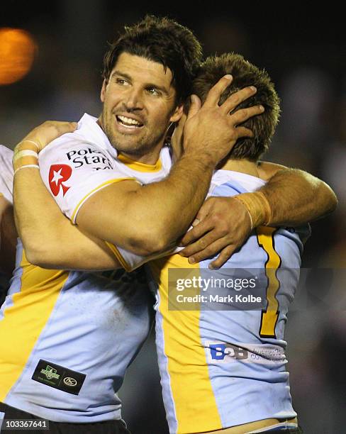 Trent Barrett and Nathan Gardner of the Sharks celebrate winning the round 23 NRL match between the Cronulla Sharks and the Sydney Roosters at Toyota...