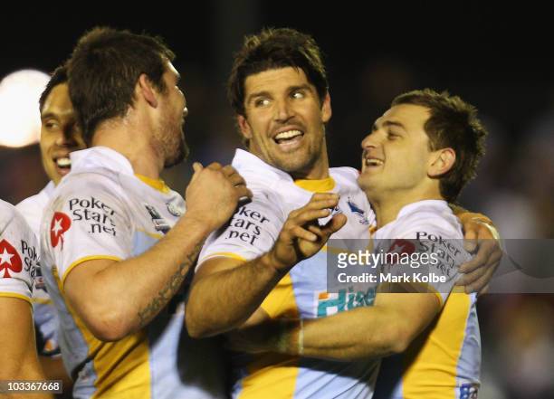 Trent Barrett and Nathan Gardner of the Sharks celebrate winning the round 23 NRL match between the Cronulla Sharks and the Sydney Roosters at Toyota...