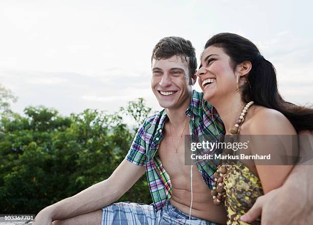 happy couple laughing while sharing mp3 player.  - 60161 imagens e fotografias de stock