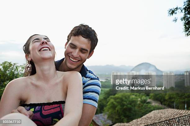 happy couple laughing on a roof top - 60161 imagens e fotografias de stock