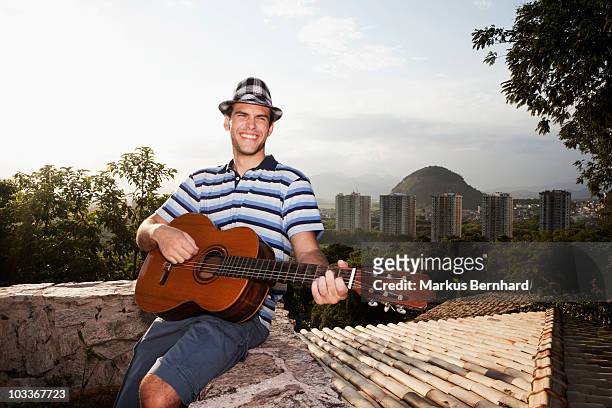 young man laughing while playing guitar - 60161 imagens e fotografias de stock