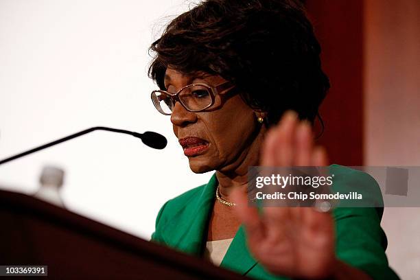 Rep. Maxine Waters holds up her hand in an attempt to stop photographers from taking her picture during a news conference she called to challenge the...