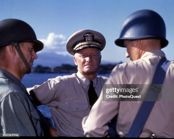 American military commander Admiral Chester William Nimitz discusses strategy for the Gilbert and Marshall Islands campaign with two unidentified...