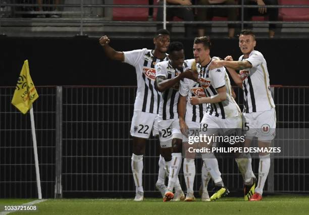 Angers' French midfielder Baptiste Santamaria celebrates with teammates after scoring during the French L1 football match between Dijon FCO and SCO...