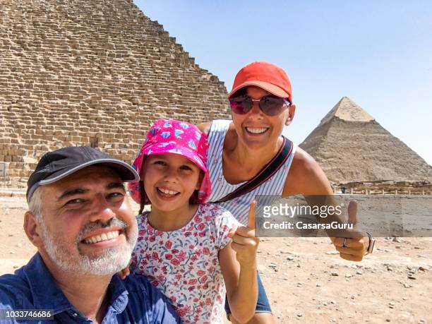 family enjoying visiting pyramids of giza - egyptian family stock pictures, royalty-free photos & images