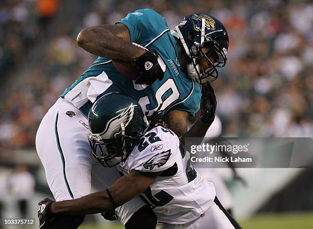 Marcedes Lewis of the Jacksonville Jaguars is tackled by Asante Samuel of the Philadelphia Eagles during their preseason game at Lincoln Financial...