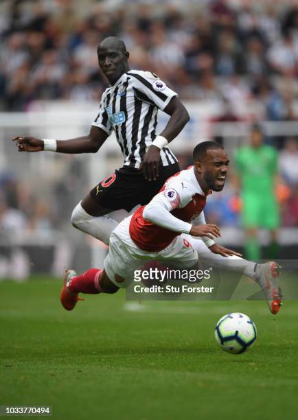 Arsenal player Alexandre Lacazette is fouled by Mohammed Diame of Newcastle during the Premier League match between Newcastle United and Arsenal FC...