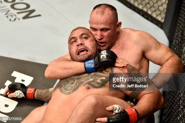 Aleksei Oleinik of Russia attempts to submit Mark Hunt of New Zealand in their heavyweight bout during the UFC Fight Night event at Olimpiysky Arena...