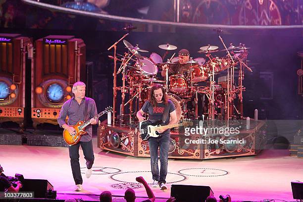 Guitarist Alex Lifeson, drummer Neil Peart and Bass/singer Geddy Lee of the band Rush perform at Verizon Wireless Amphitheater on August 13, 2010 in...