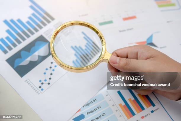 analysing financial data with a magnifying glass - information equipment stock pictures, royalty-free photos & images