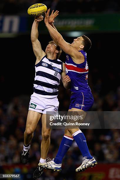 Darren Milburn of the Cats spoils a mark by Will Minson of the Bulldogs during the round 20 AFL match between the Western Bulldogs and the Geelong...