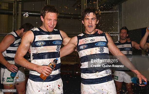Jeremy Laidler and Daniel Menzel of the Cats sing the song in the rooms after winning the round 20 AFL match between the Western Bulldogs and the...