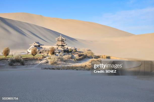 china, gansu province, dunhuang, crescent lake (yueyaquan), temple in the desert surrounded by frozen sand dunes - silk road foto e immagini stock