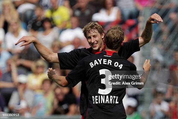 Stefan Kiessling of Leverkusen celebrates his team's first goal with team mate Stefan Reinartz during the DFB Cup first round match between FK...