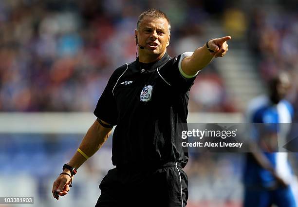 Referee Mark Halsey gestures during the Barclays Premier League match between Wigan Athletic and Blackpool at the DW Stadium on August 14, 2010 in...