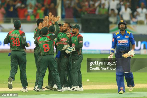 Bangladesh cricketers celebrate during the first cricket match of Asia Cup 2018 between Sri Lanka and Bangladesh in Dubai, United Arab Emirates, on...