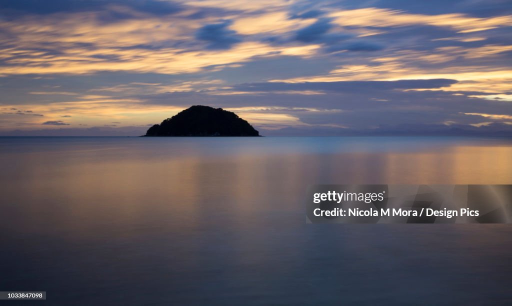 Beautiful sunrise reflected in the tranquil waters of the Pacific Ocean, Abel Tasman National Park