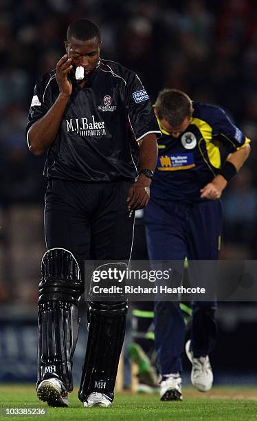 Kieron Pollard of Somerset has to retire hurt after the ball got through his helmet and face guard from a Dominic Cork delivery during the Friends...