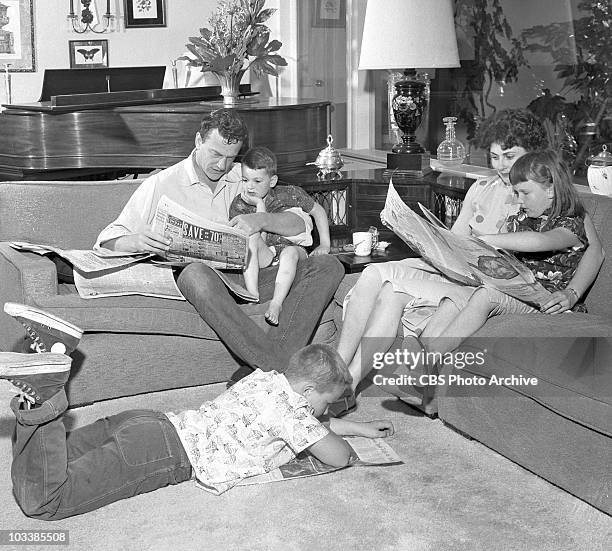 The Arness family at home. James Arness with Rolf , Virginia with daughter Jenny Lee and Craig on the floor. Image date May 4, 1957.