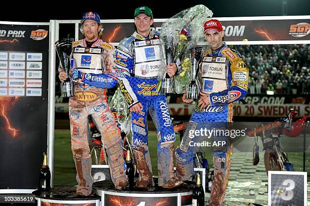 1st placed Rune Holta of Poland, 2nd Jason Crump of Australia and 3rd Tomasz Gollob of Poland pose on the podium after the FIM Speedway Grand Prix of...