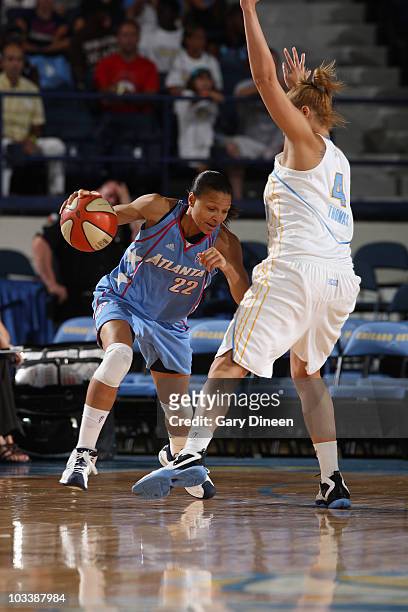 Armintie Price of the Atlanta Dream drives on Christi Thomas of the Chicago Sky during the WNBA game on August 14, 2010 at the All-State Arena in...