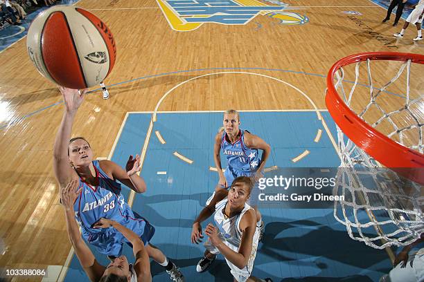 Alison Bales of the Atlanta Dream shoots over Erin Torn and Christi Thomas of the Chicago Sky during the WNBA game on August 14, 2010 at the...