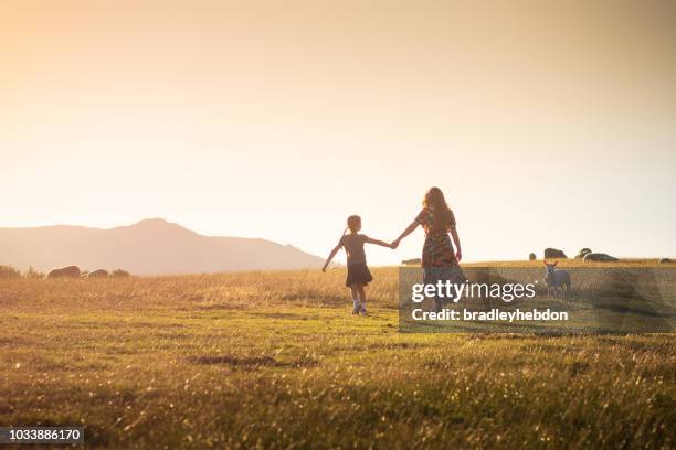 little girl and her mother going for walk through the rural sunset pastures of keswick, england - sheep walking stock pictures, royalty-free photos & images