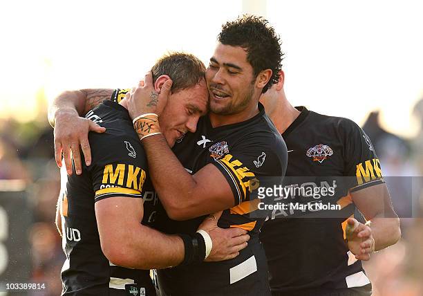 Gareth Ellis of the Tigers is congratulated by team mate Andrew Fifita after scoring a try during the round 23 NRL match between the Wests Tigers and...