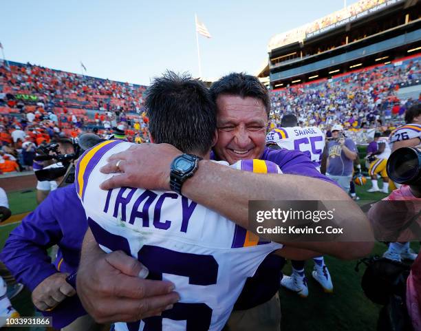 Head coach Ed Orgeron hugs Cole Tracy of the LSU Tigers after he kicked the game-winning field goal in their 22-21 win over the Auburn Tigers at...