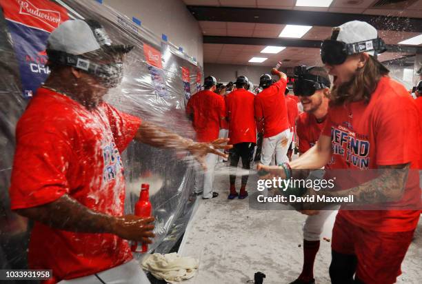 Trevor Bauer and Mike Clevinger of the Cleveland Indians douse teammate Jose Ramirez during a locker room celebration after the Indians defeated the...