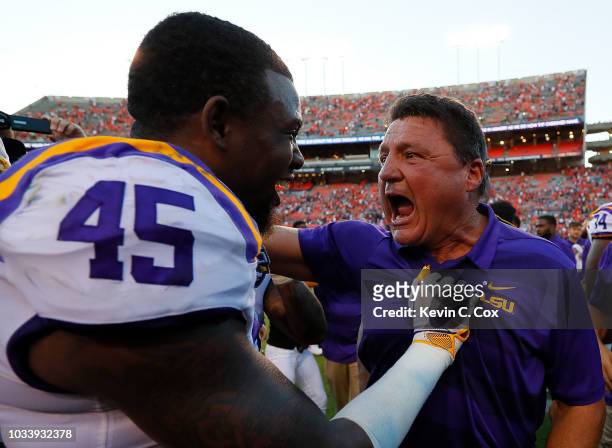 Head coach Ed Orgeron celebrates with Michael Divinity Jr. #45 of the LSU Tigers after their 22-21 win over the Auburn Tigers at Jordan-Hare Stadium...