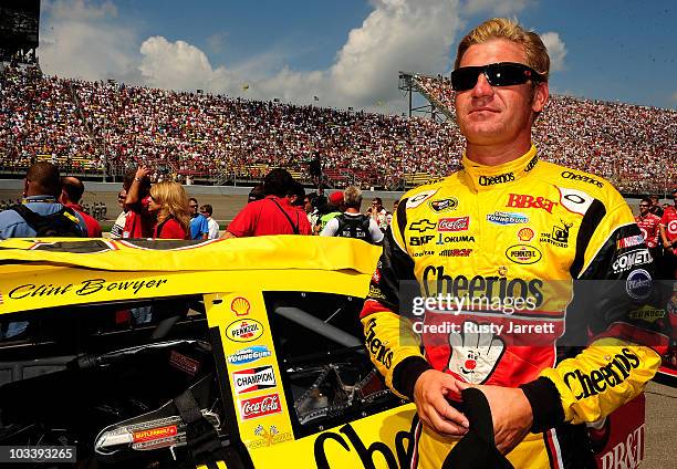 Clint Bowyer, driver of the Cheerios / Hamburger Helper Chevrolet, looks on from the grid during the NASCAR Sprint Cup Series CARFAX 400 at Michigan...