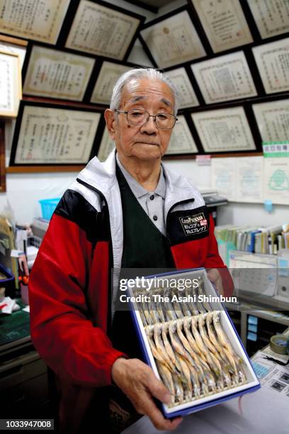 Owner of fishery shop 'Suzuki', Yuzuru Suzuki, younger brother of Nobel Prize laureate Akira Suzuki, poses for photographs a week after the magnitude...