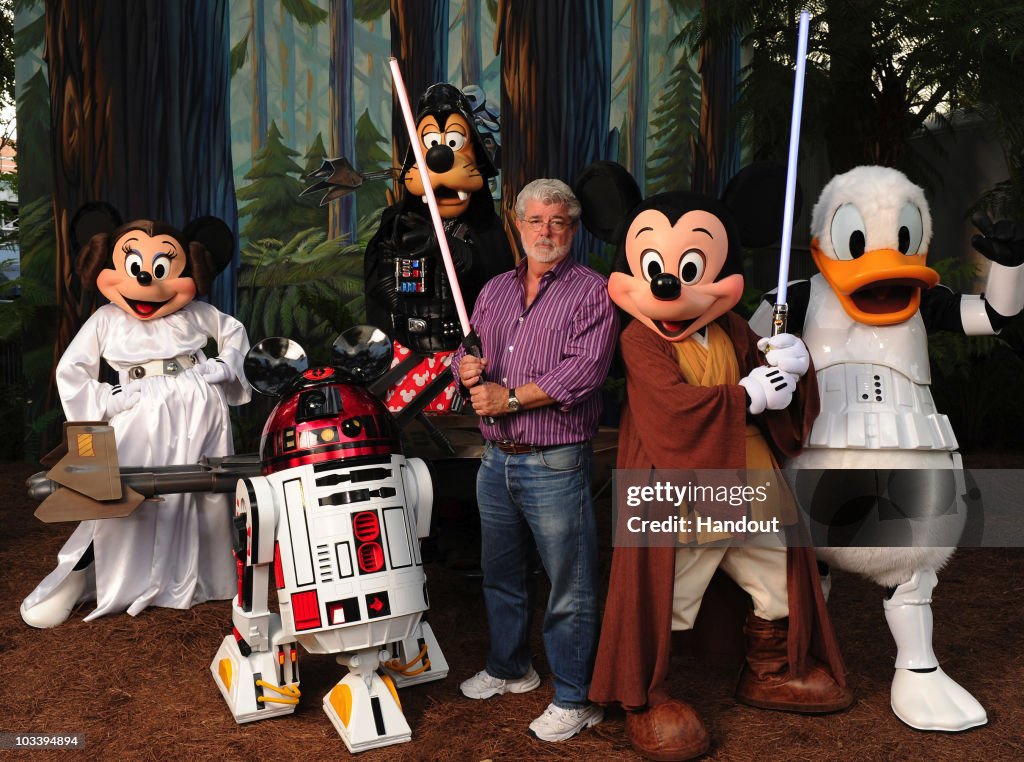 George Lucas Poses With A Group Of "Star Wars" Inspired Disney Characters At Disney's Hollywood Studios