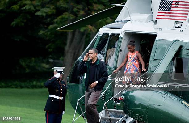 President Barack Obama and his daughter Sasha get off Marine One on the South Lawn of the White House August 15, 2010 in Washington, DC. President...