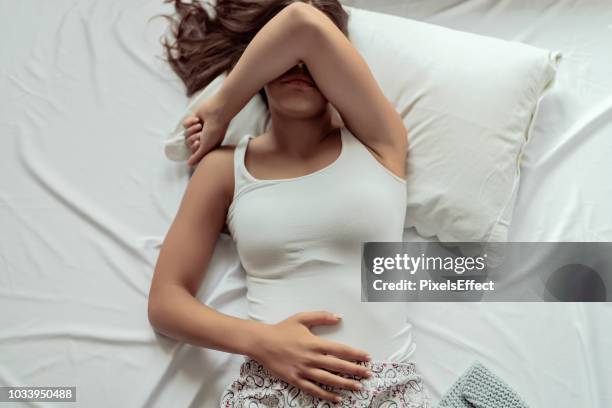 some mornings are a struggle to get out of bed - menses stock pictures, royalty-free photos & images
