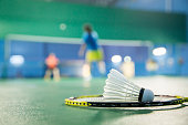Badminton courts with players competing