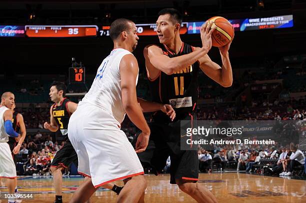 Yi Jianlian of China looks to shoot against Ricardo Sanchez of the Puerto Rico on August 15, 2010 at Madison Square Garden in New York City. NOTE TO...