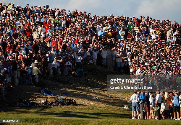 Dustin Johnson watches his second shot on the 18th hole during the final round of the 92nd PGA Championship on the Straits Course at Whistling...