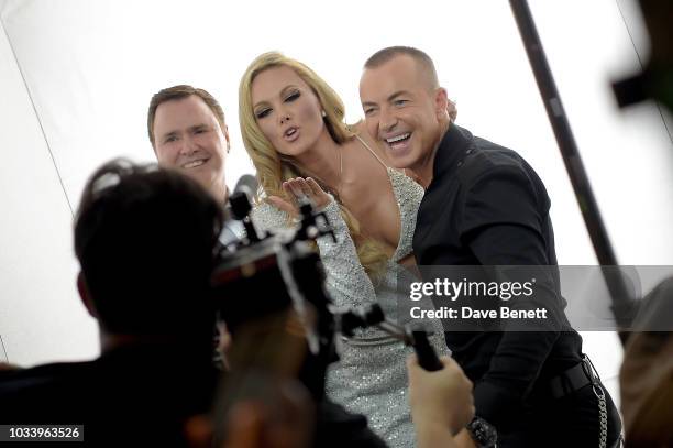 Designer Julien Macdonald with a model at the Julien Macdonald SS19 Show - Backstage on September 15, 2018 in London, England.