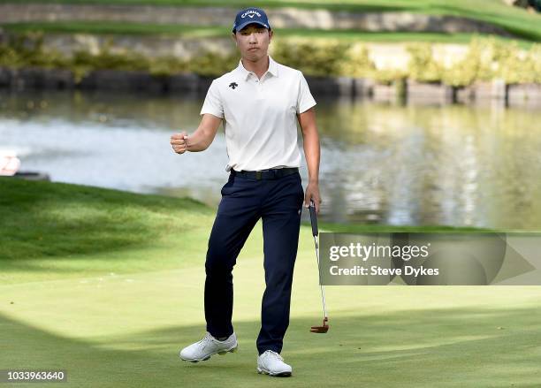 Sangmoon Bae of the Republic of Korea reacts after sinking his birdie putt on the 17th hole during the third round of the Albertsons Boise Open at...