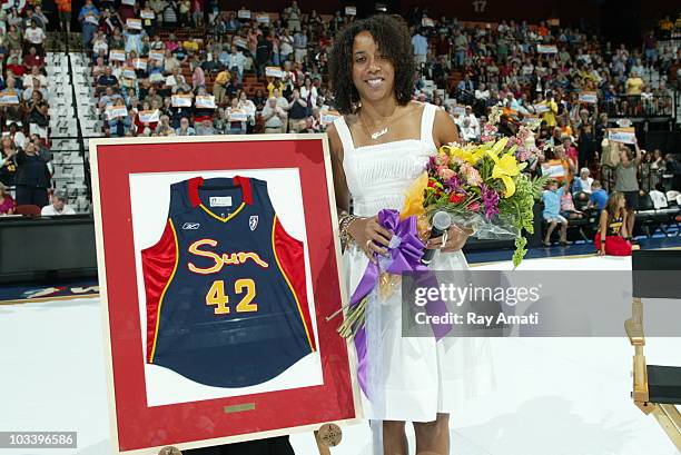 August 15: Former Connecticut Sun player Nykesha Sales poses with her framed jersey and flowers that were presented to her as part of Nykesha Sales...