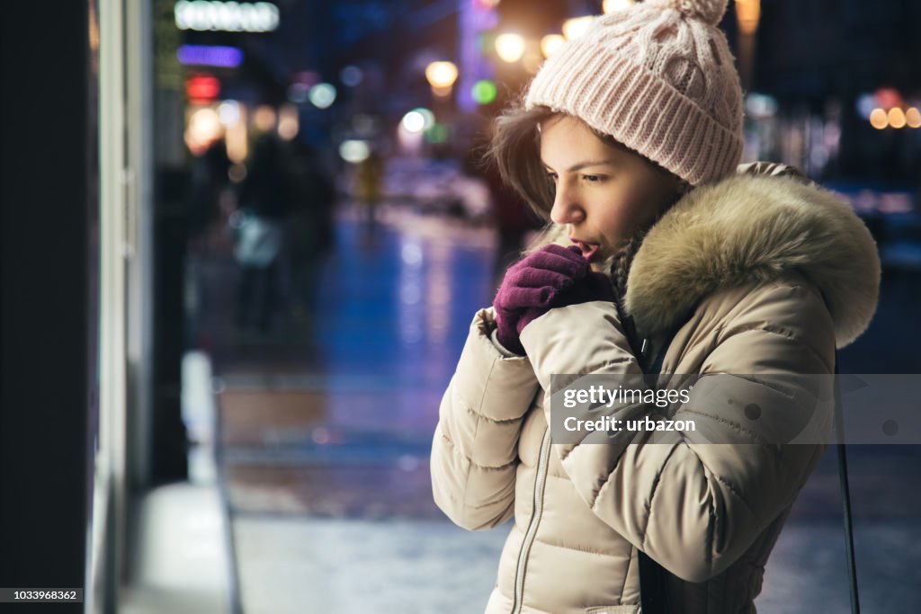 Woman is feeling cold downtown